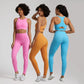Three women wearing colorful Naked brand seamless leggings and scoop-neck sports bras in pink, orange, and blue, modeled for yoga and workouts